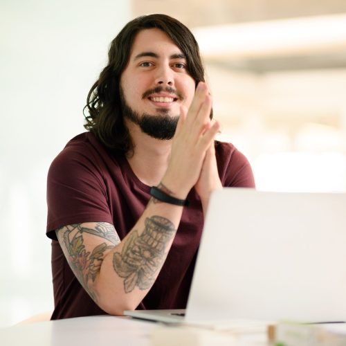 Hard work and dedication leads to a successful career. Portrait of a young businessman working on a laptop in an office. Hard work and dedication leads to a successful career. Portrait of a young businessman working on a laptop in an office